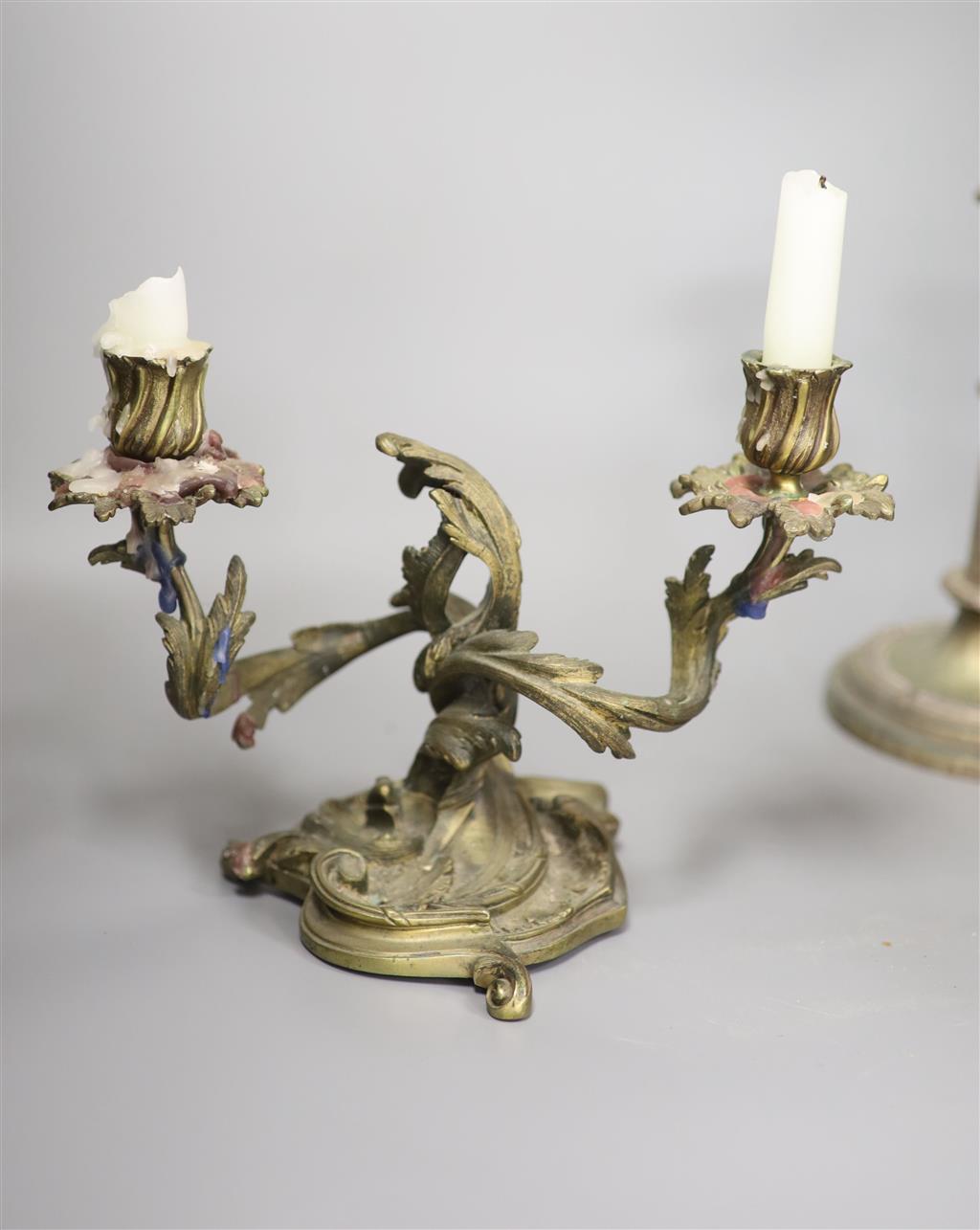 A pair of bronze rococo-style candelabra, width 25cm and a pair of telescopic candlesticks